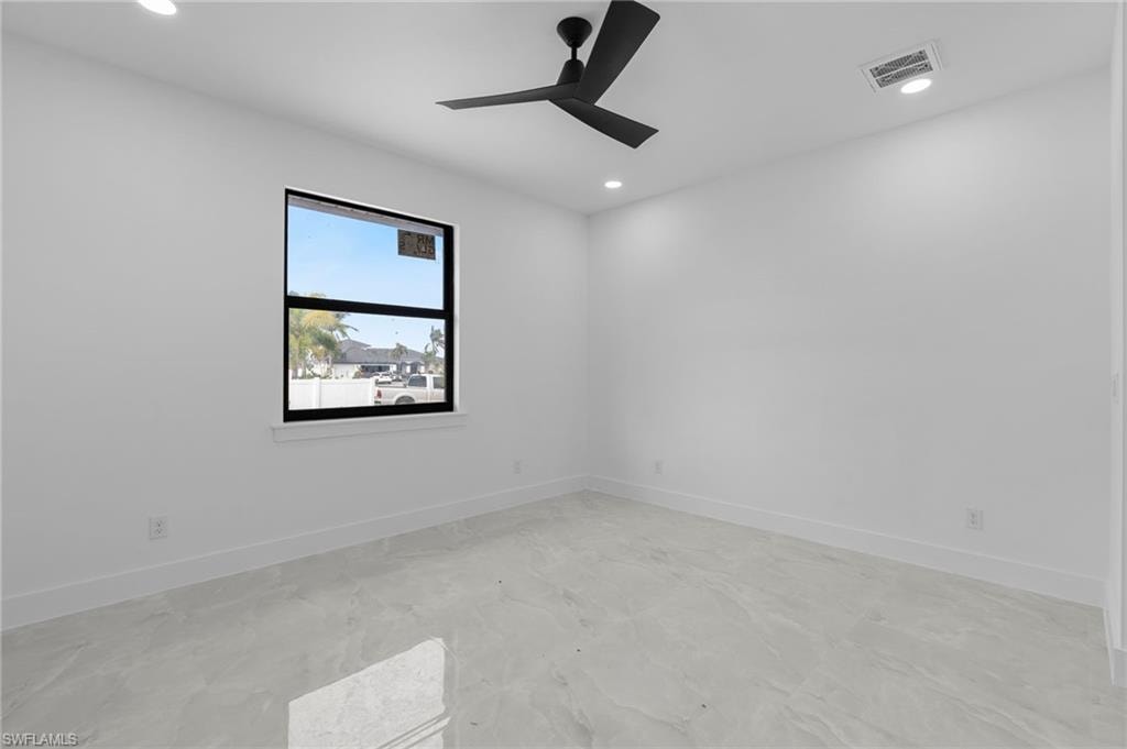 Spare room with ceiling fan
