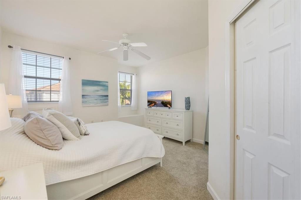 Bedroom featuring light carpet and a ceiling fan