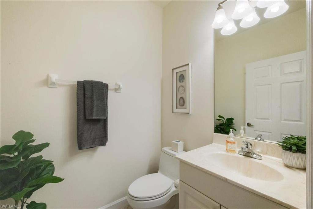 Half bath with vanity and a chandelier