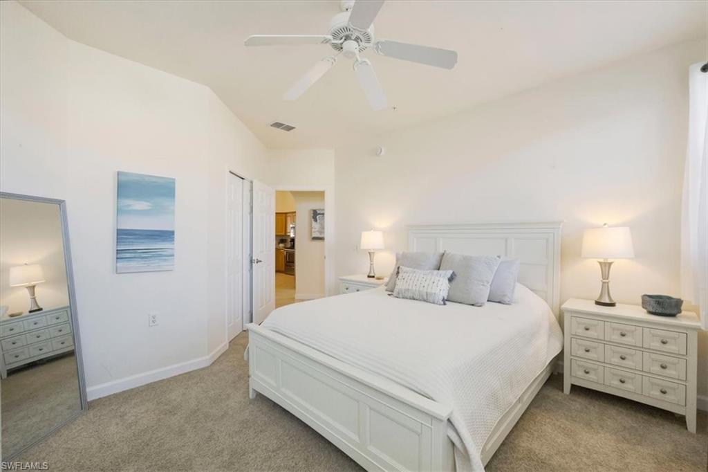 Bedroom with light carpet and ceiling fan