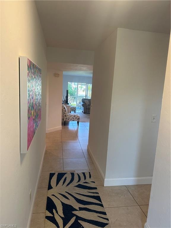 Hall featuring light tile patterned floors