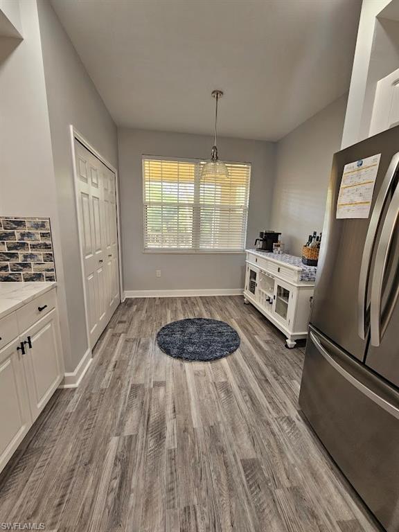 Dining space featuring baseboards and wood finished floors