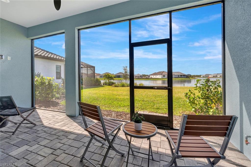 Sunroom / solarium featuring a water view