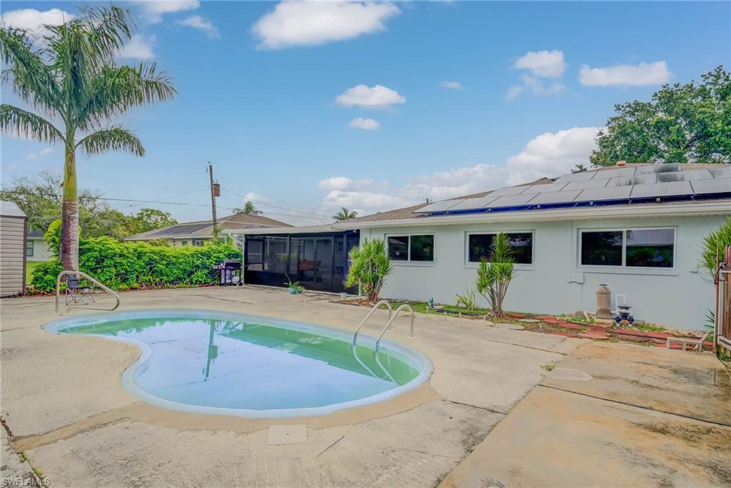 Kidney-shaped in-ground pool with concrete surround