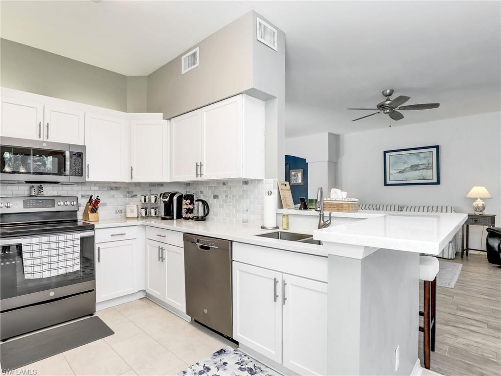 Kitchen with Stainless Steel Appliances & Breakfast Bar