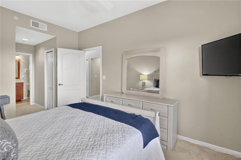 Carpeted bedroom with neutral wall tones and a ceiling fan