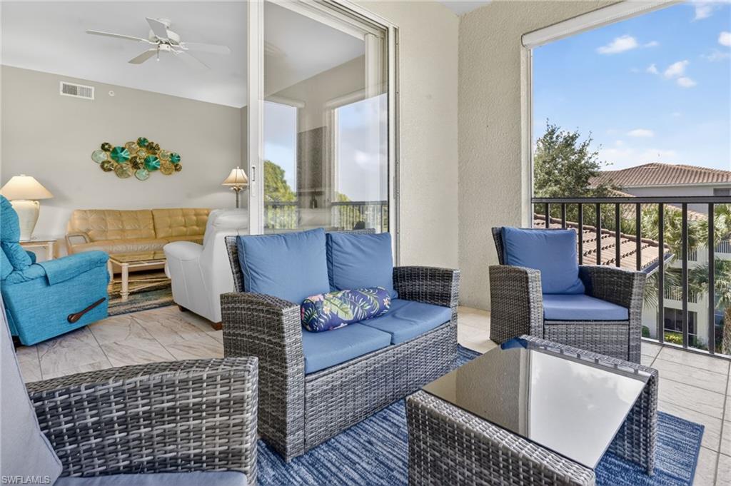 Tiled balcony featuring a black iron railing, providing an open-air extension of the interior living area with sliding glass doors