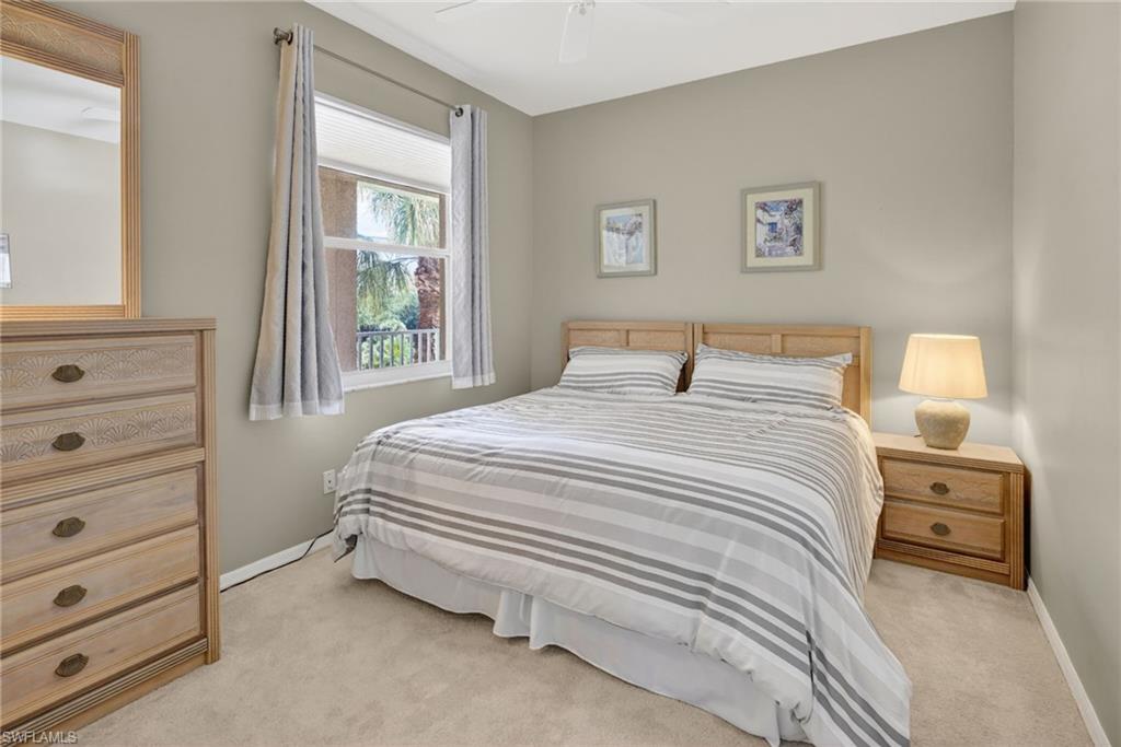 Carpeted room featuring neutral wall tones, a double-paned window, and a ceiling fan