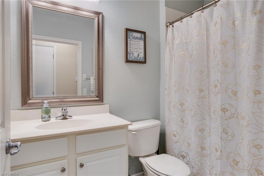 Bathroom vanity with a framed mirror, an integrated sink, a two-door cabinet, and a chrome faucet