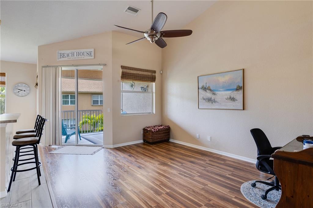 Open living area featuring vaulted ceilings and wood-finish flooring