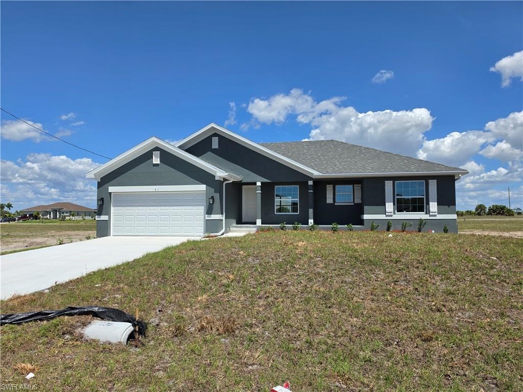Contemporary ranch-style exterior featuring a cool gray facade with white trim accents and dark gray architectural shingles