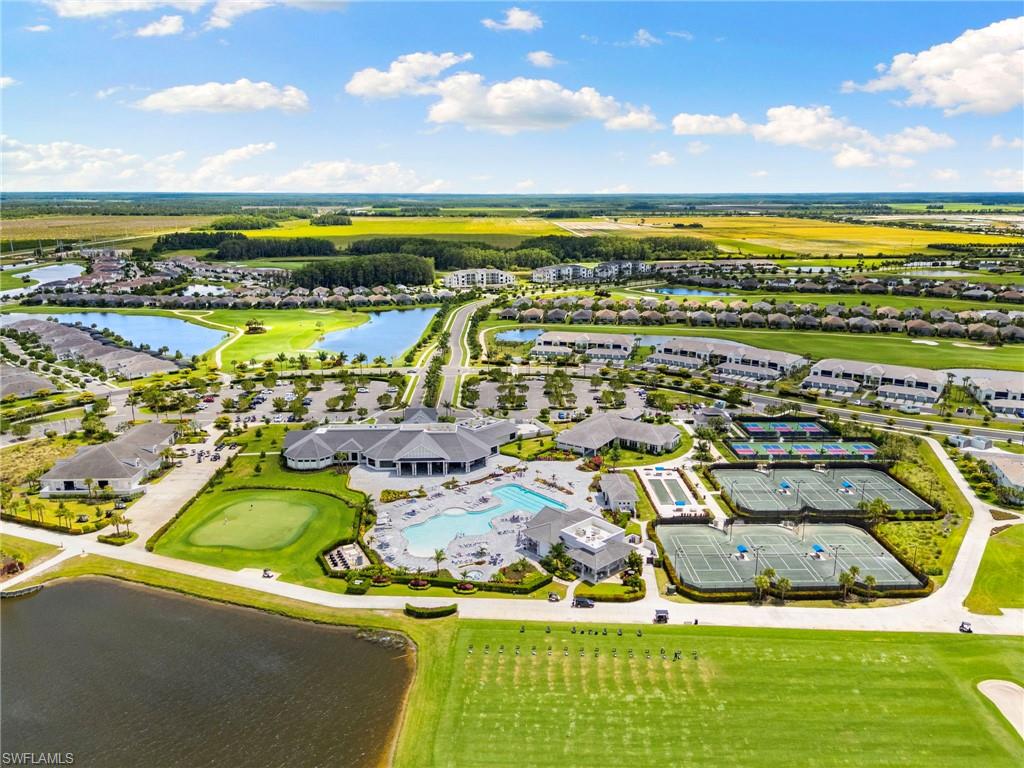 Expansive community featuring a central clubhouse, multiple swimming pools, and dedicated tennis courts