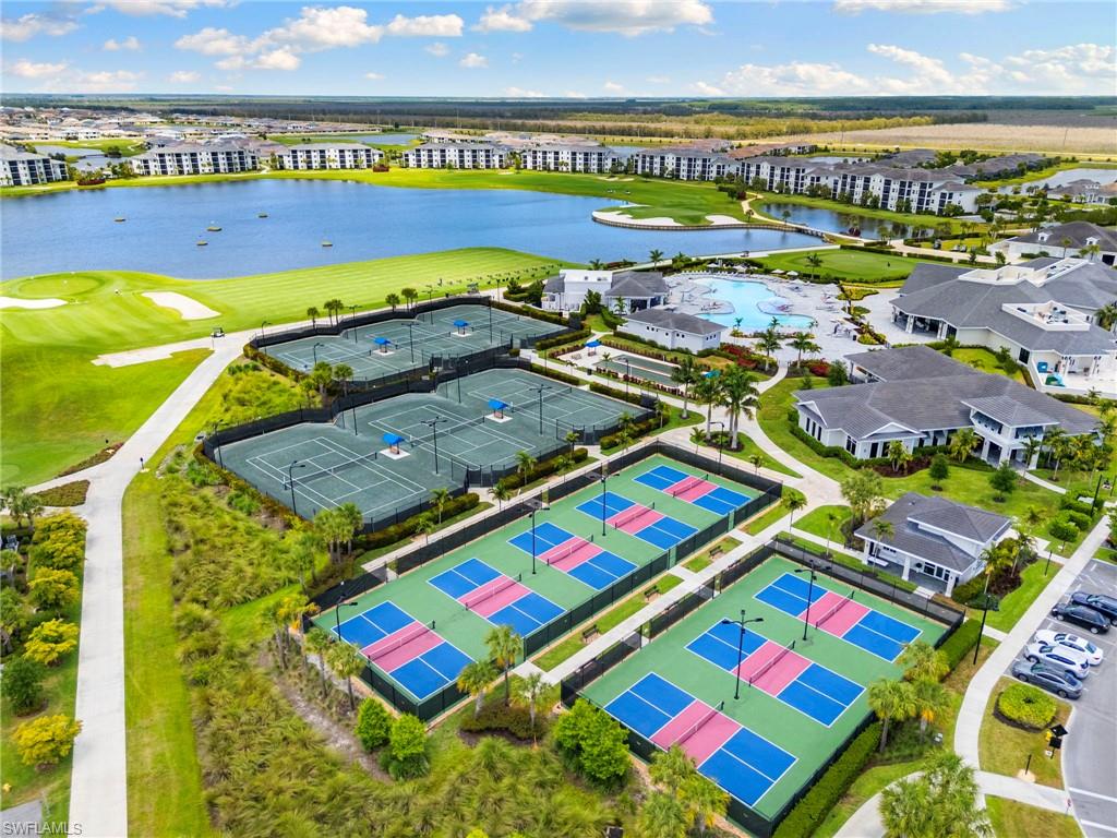 Tennis and pickleball courts with perimeter fencing and surrounding landscaping