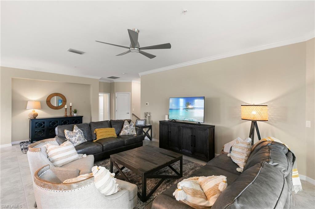 Spacious common area featuring crown molding, recessed lighting, a contemporary ceiling fan, and tile flooring