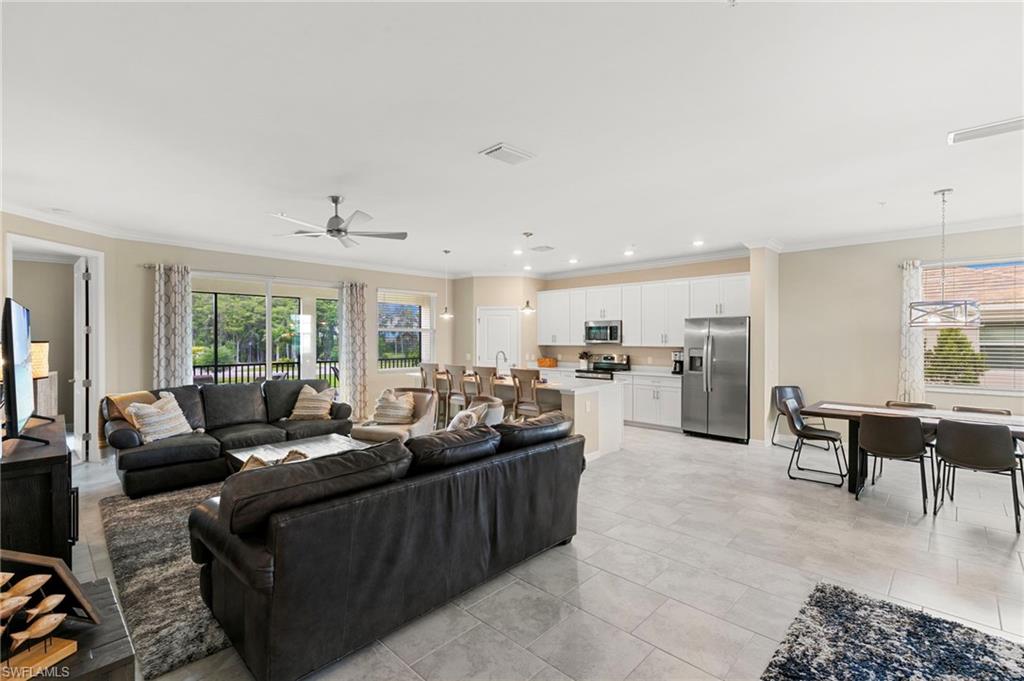 Open-concept living area with light-toned tile flooring throughout
