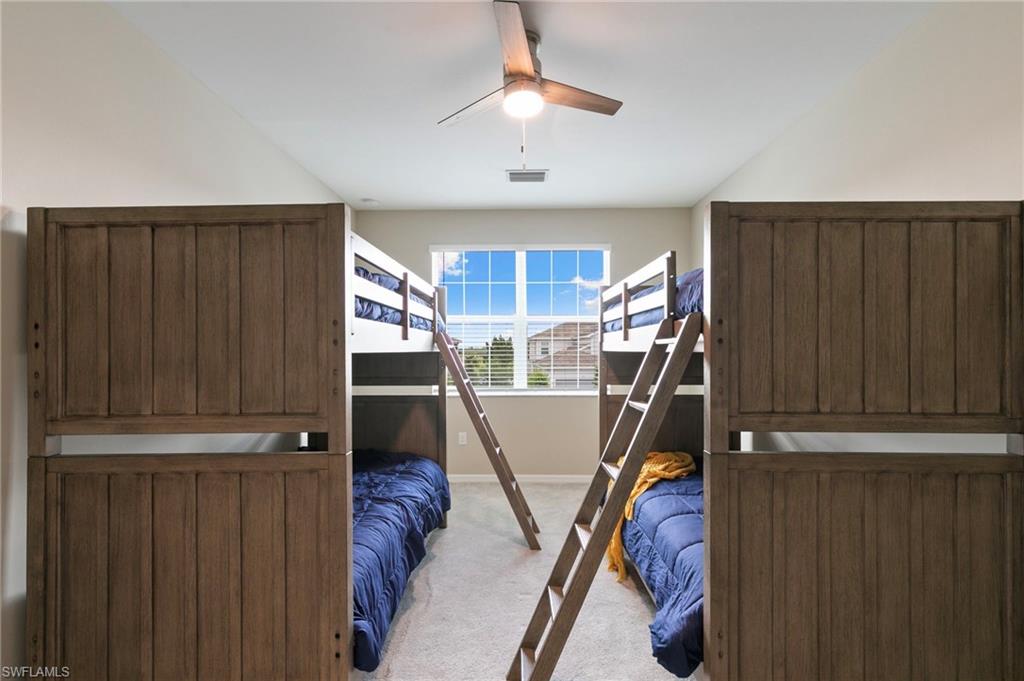 Room with vaulted ceiling, ceiling fan, and carpeted flooring