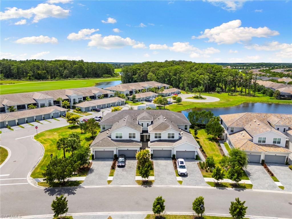 Modern townhome community featuring paver driveways, attached garages, and a neutral exterior palette