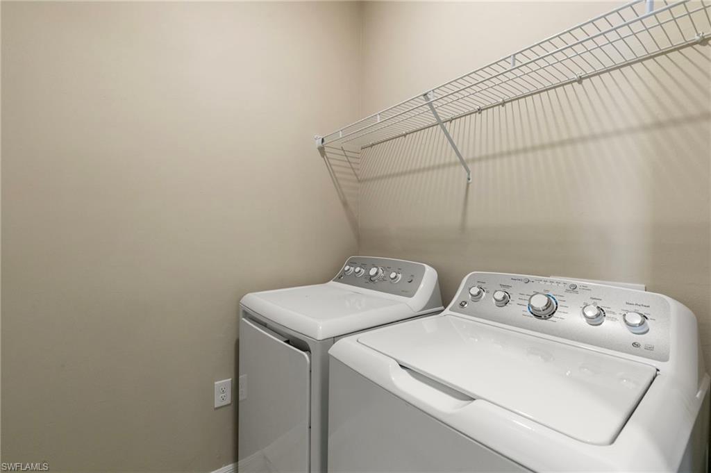 Dedicated laundry area featuring a wire shelving unit