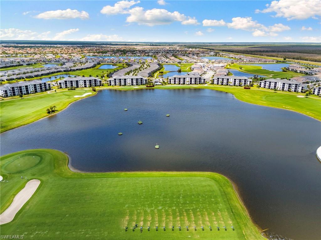 Expansive golf course and water features with surrounding residential buildings