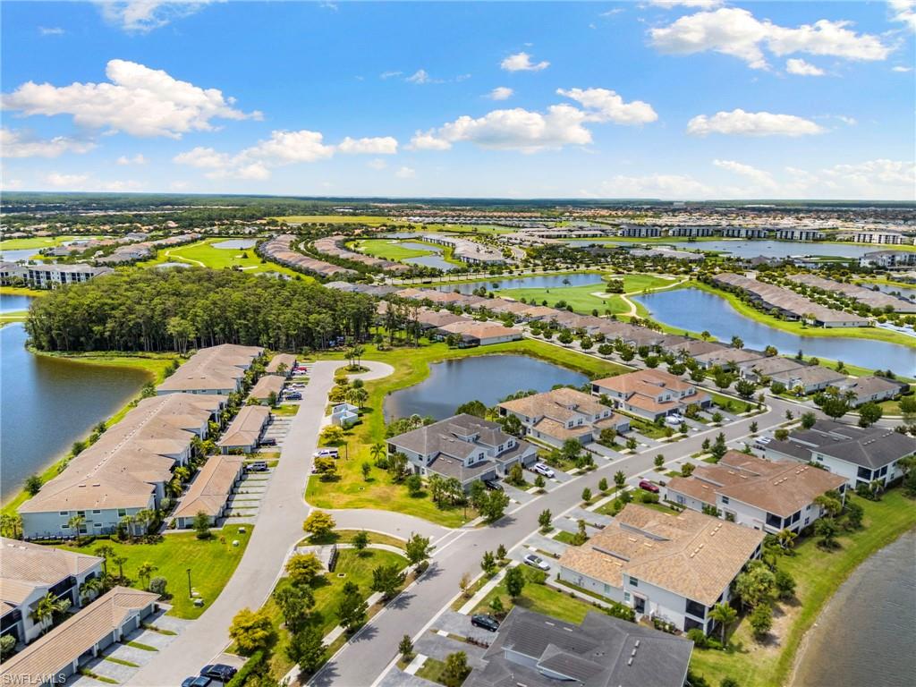 Aerial perspective showcasing a residential community with water features and extensive green spaces