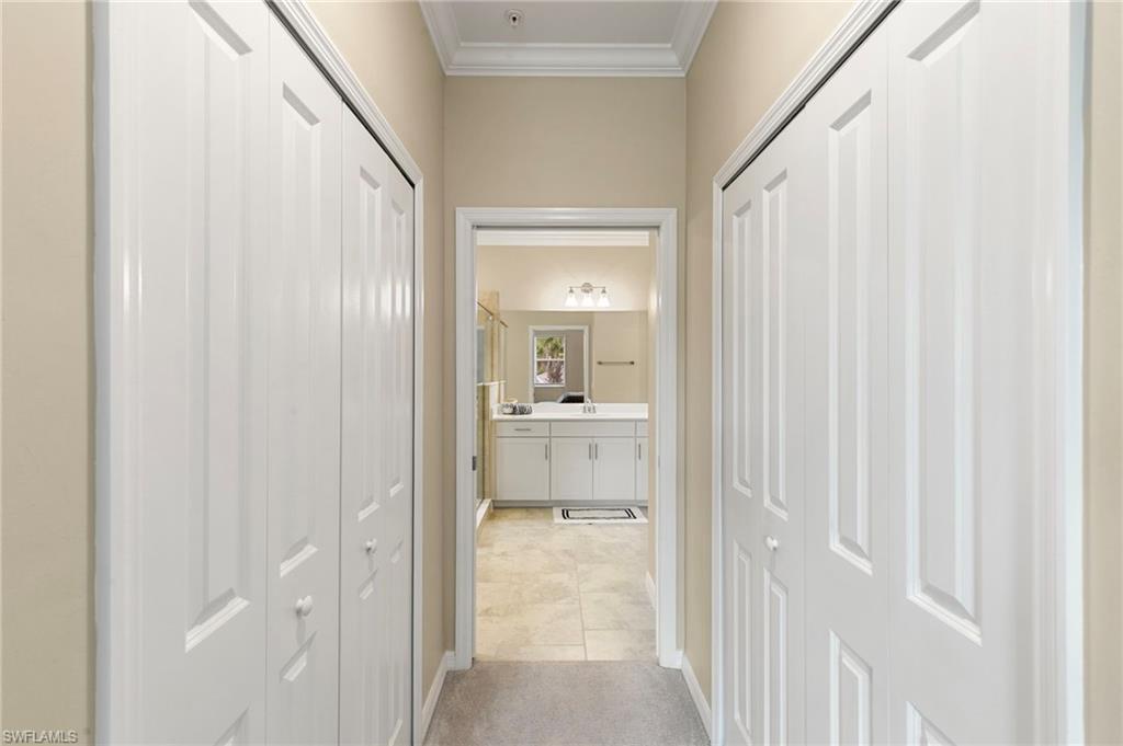 Hallway with light-colored walls and crown molding