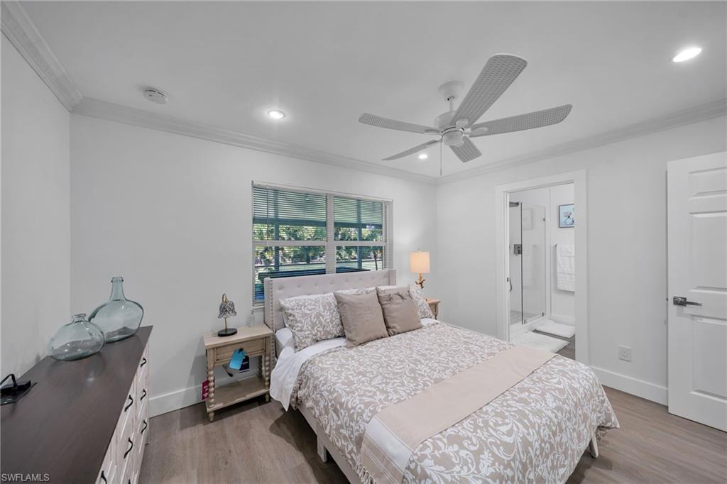 Interior room featuring wood-finish flooring and crown molding