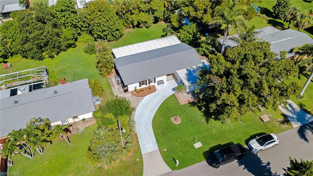 Single-story residence featuring a gray metal roof and a white exterior