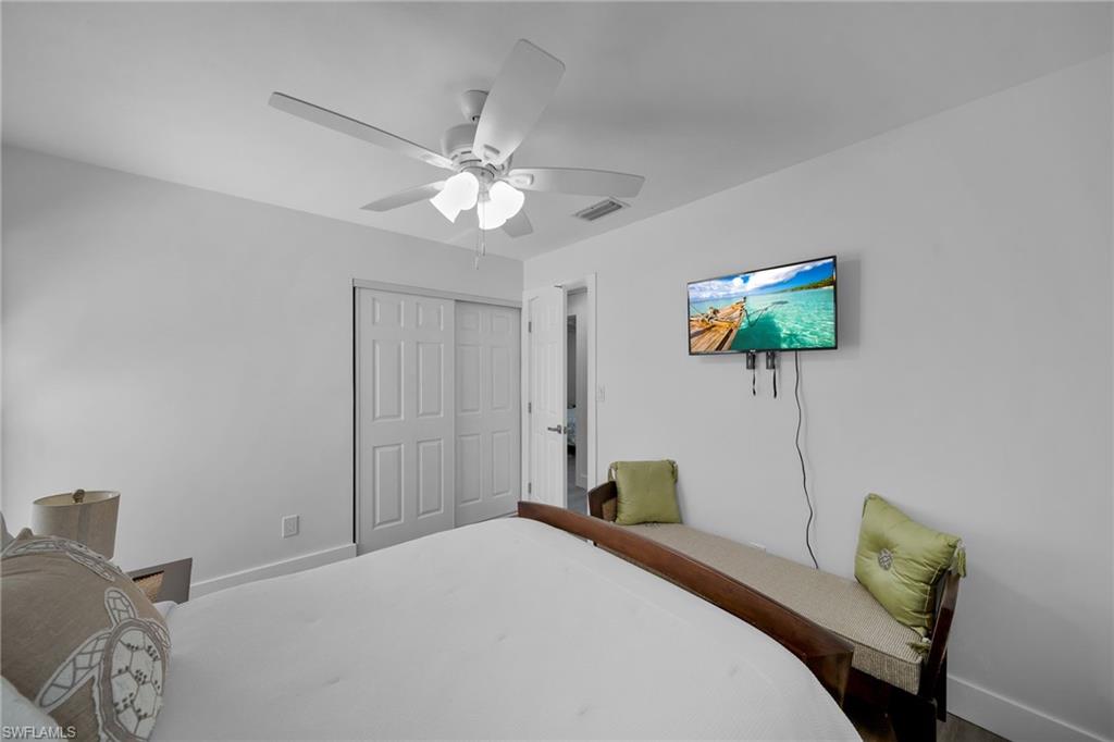 White walls featuring a ceiling fan with integrated lighting