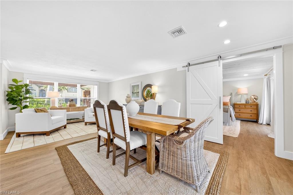Open concept living space with wood-finish flooring