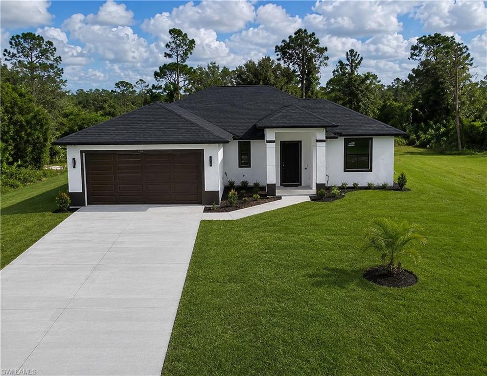 Modern stucco exterior with black-framed windows, a dark shingle roof, a two-car garage with a paneled brown door, a concrete driveway, and established front landscaping