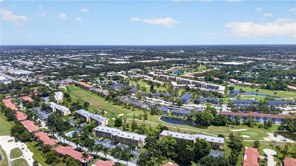 Expansive golf course setting featuring multiple greens and water features