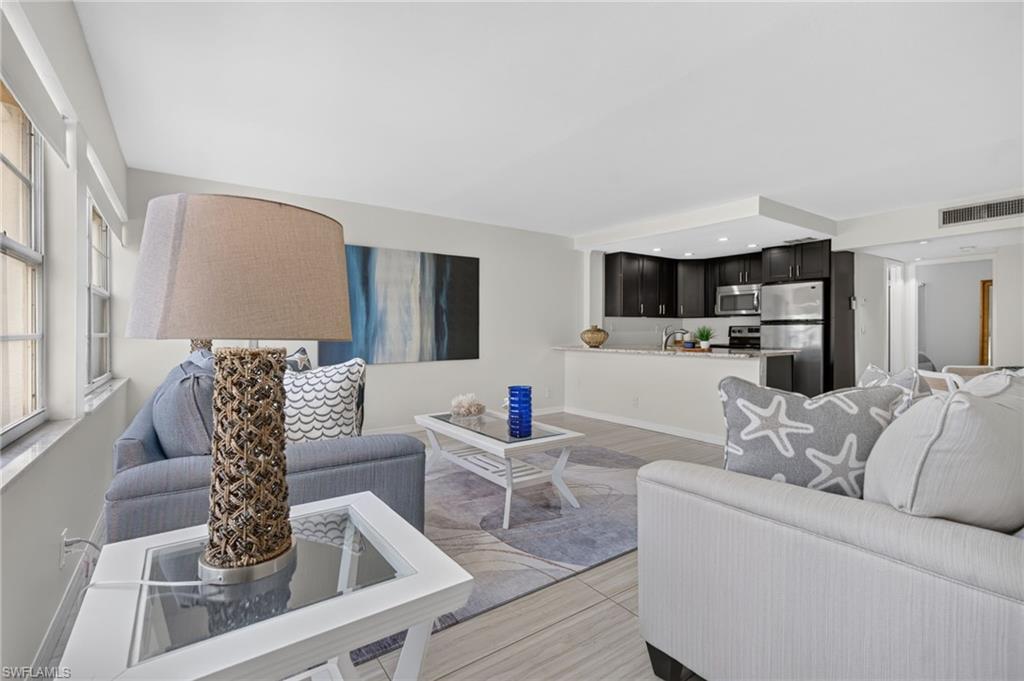Open-concept living area with light-toned flooring