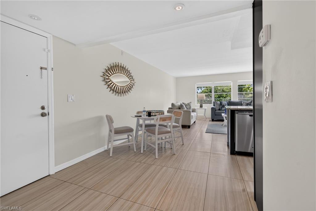 Recessed lighting illuminating wood-finish tile flooring