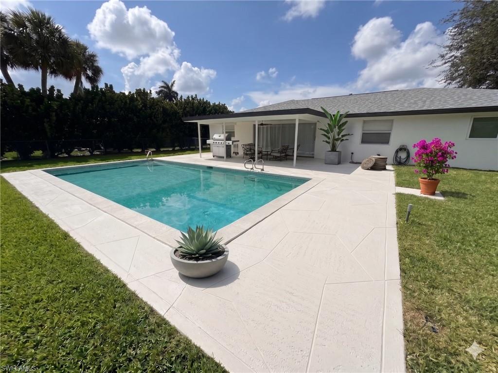 Rectangular swimming pool with light-colored coping and surrounding patio