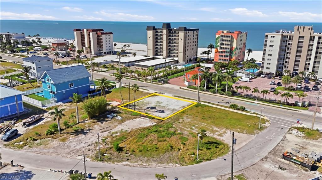 Vacant lot outlined in yellow, featuring a clear building site and proximity to the Gulf of Mexico - Virtually Edited Image