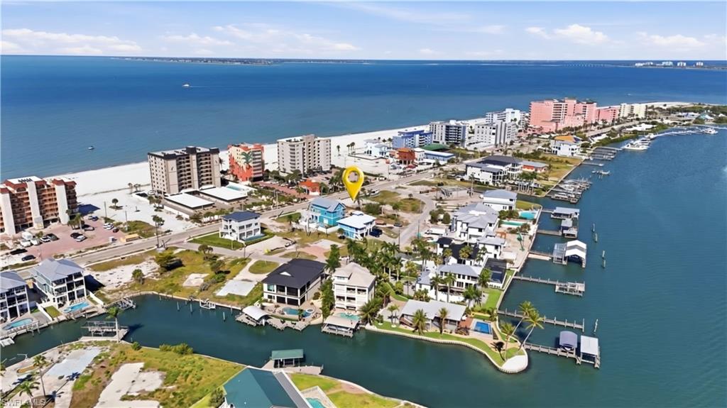 Coastal property featuring beach proximity, waterfront access with boat docks, and surrounding residential structures - Virtually Edited Image