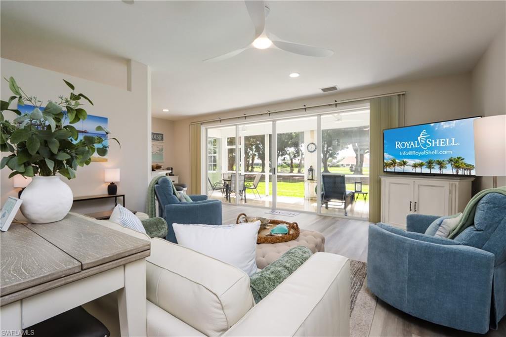Living room with ceiling fan, wood finished floors, and recessed lighting
