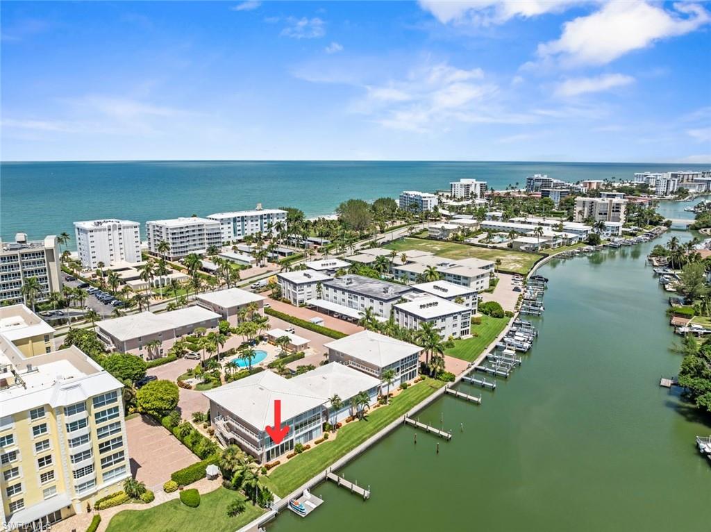 Waterfront condominium with direct Gulf access, featuring private boat slips, an on-site swimming pool, and proximity to the open water