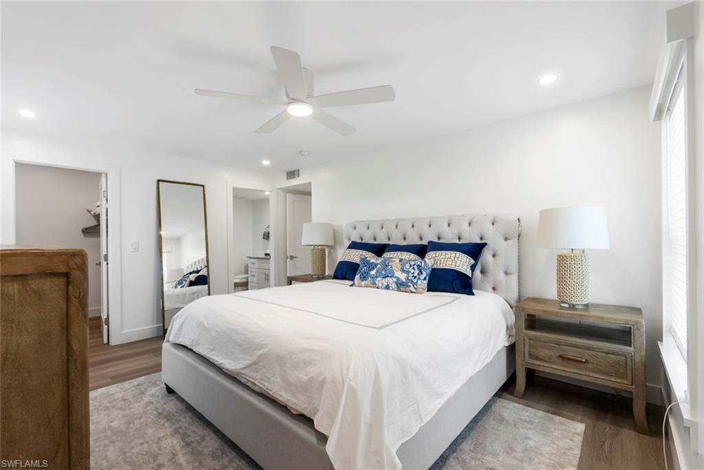 Spacious room with light wood-finish flooring and bright white walls