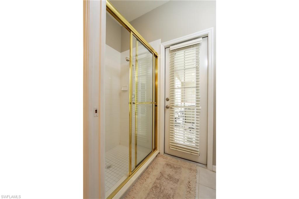 Bathroom featuring tile patterned flooring and a shower with door