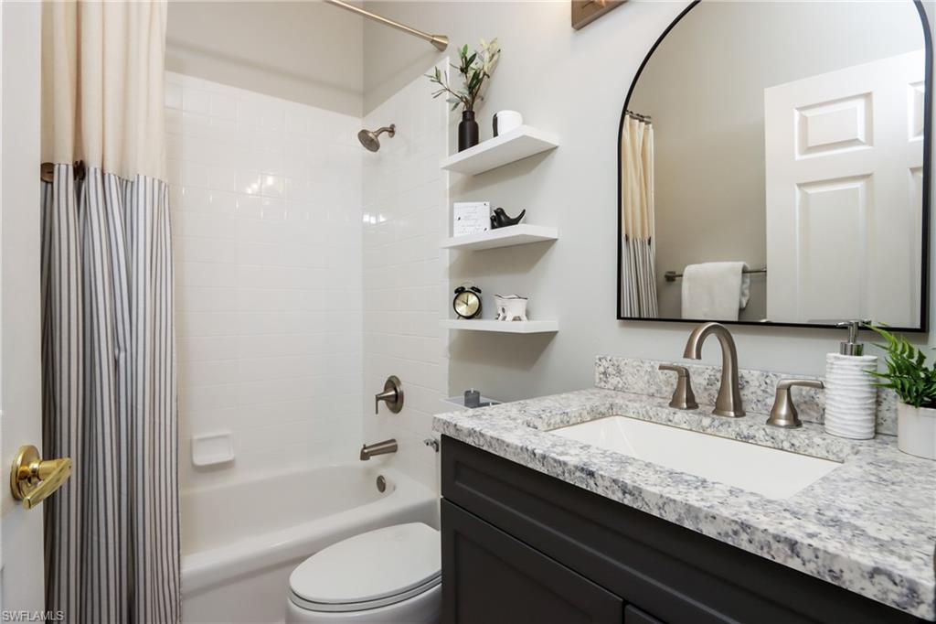 Full bath with vanity and shower / bath combo with shower curtain