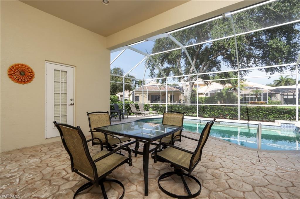 View of patio featuring an outdoor pool and glass enclosure