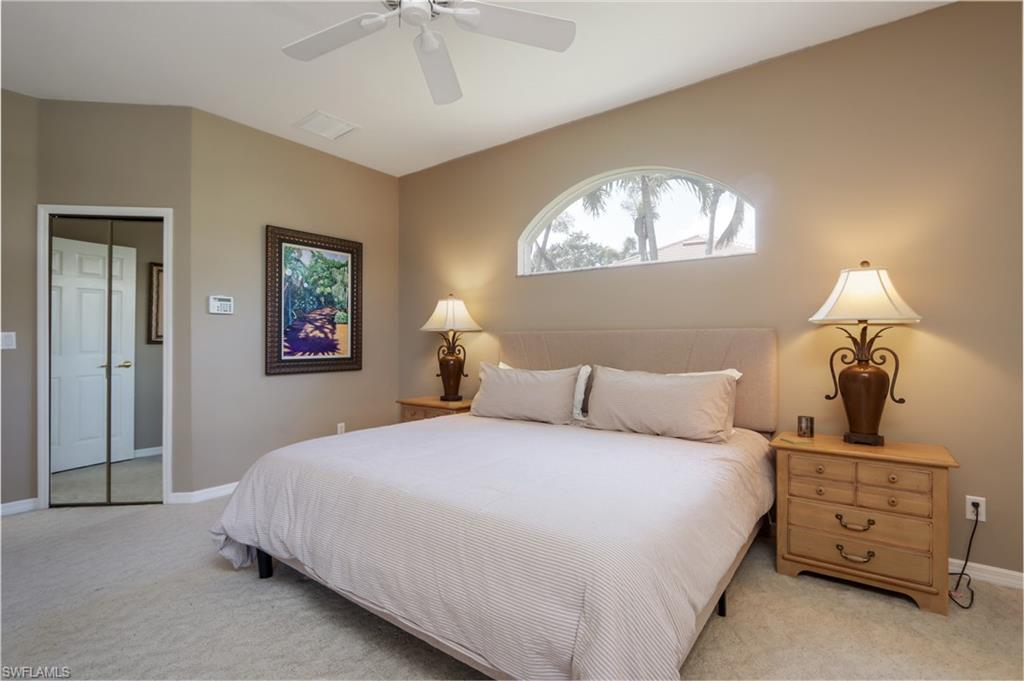 Bedroom with light colored carpet and ceiling fan