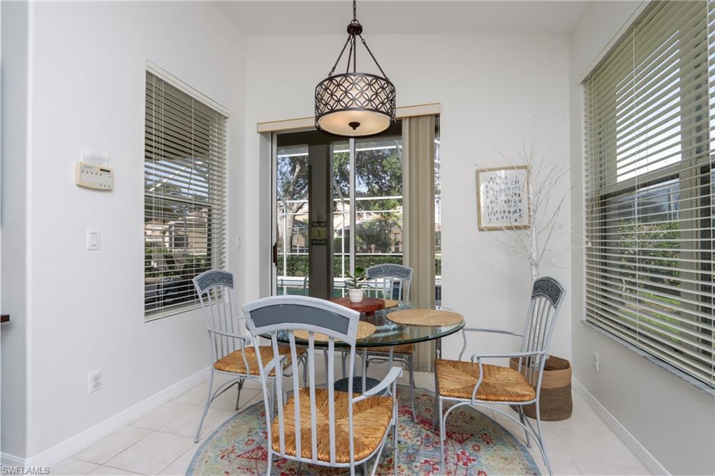 Dining room with plenty of natural light, light tile patterned floors, and french doors