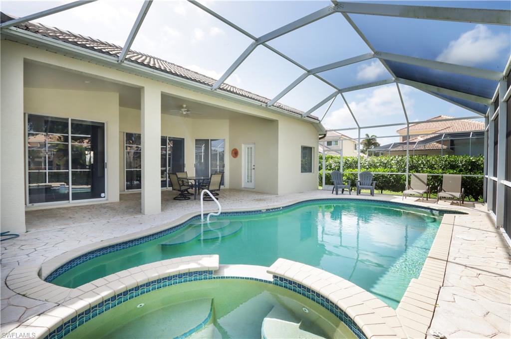 View of pool featuring a pool with connected hot tub, a patio, and a ceiling fan