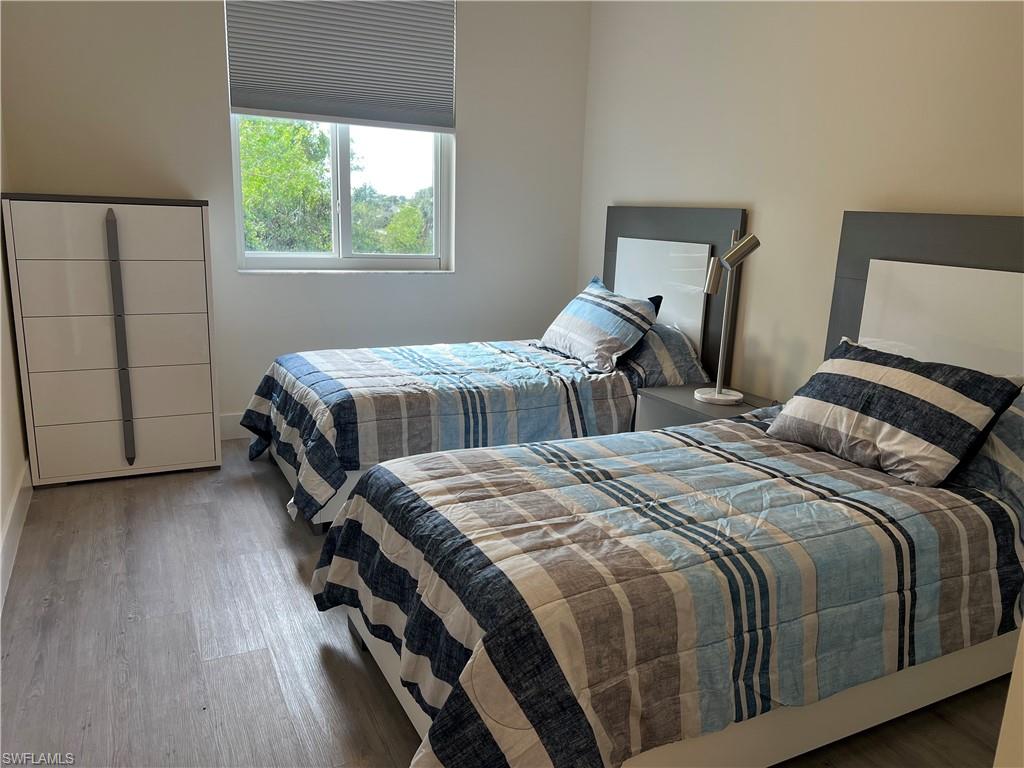 Bedroom with wood-type flooring