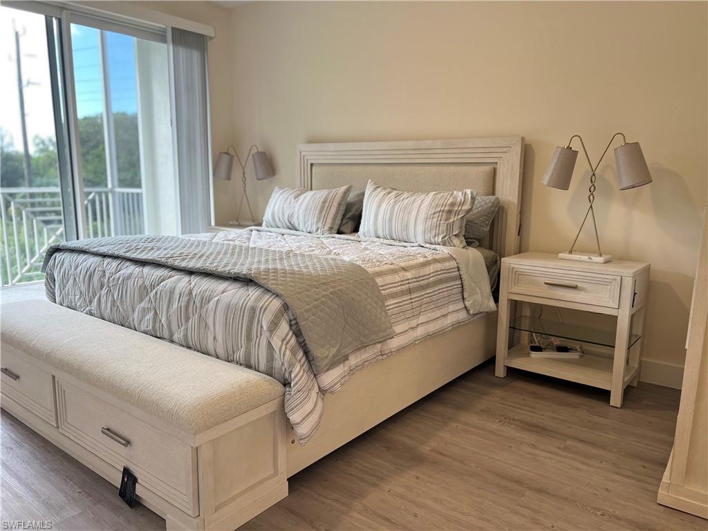 Bedroom featuring access to exterior and hardwood / wood-style floors