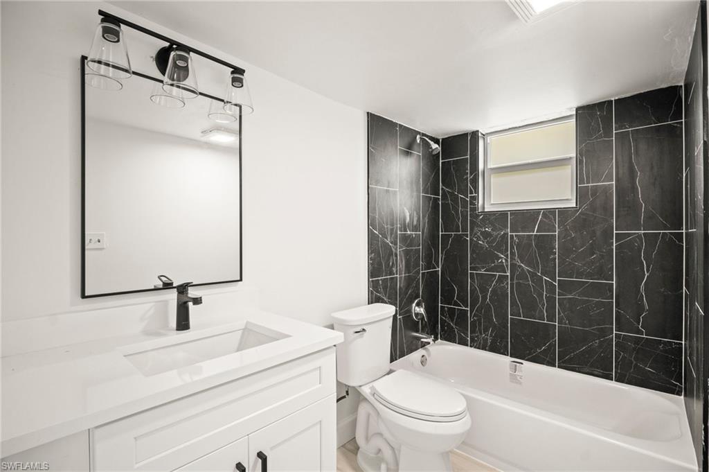Bathroom with shower / bathtub combination and vanity