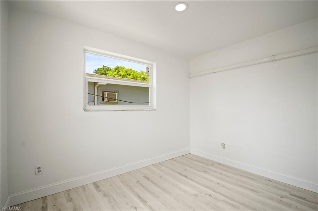 Empty room with wood finished floors and recessed lighting