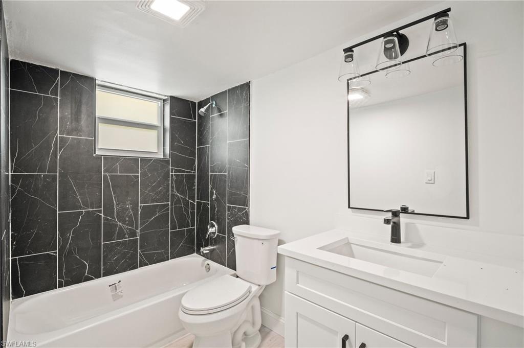 Bathroom with vanity and shower / tub combination
